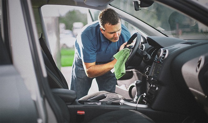 Man-Cleaning-Inside-Of-Car