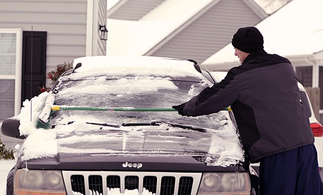 Man-Brushing-Snow-Off-Car